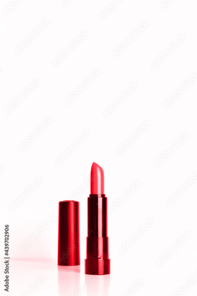 Red lipstick, base and white background, copy space. Red lipstick, base and white background, copy space.