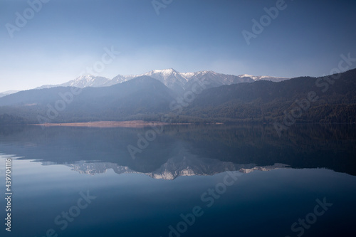 Reflection of the surrounding mountains in Rara Lake, Nepal.