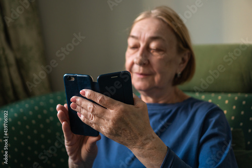 Elderly woman using phone photo