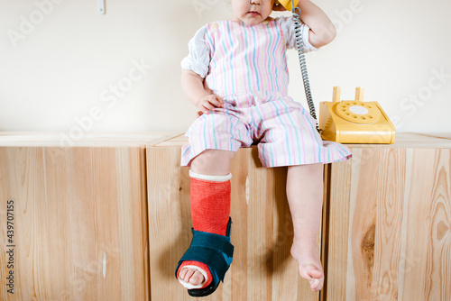 Close up of a toddler with a cast