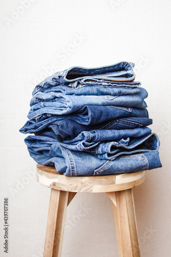 Stack of denim on a chair photo