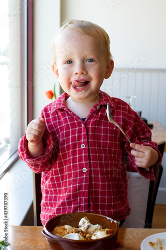 Boy eating ice cream at the restaurant