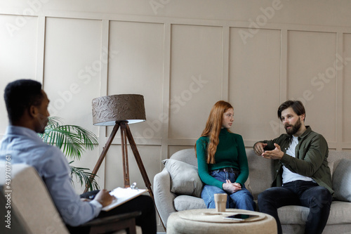 Male clients explaining situation to doctor  photo