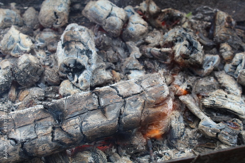 background and ash charcoal gray blacks with red stained streaks close-up. The aftermath of the fire. Ashes. bonfire