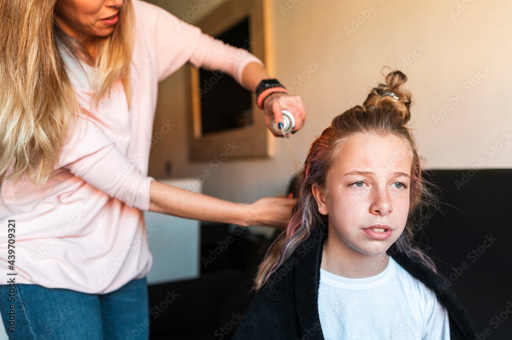 Single mother coloring hair to daughter at home Single mother coloring hair to daughter at home