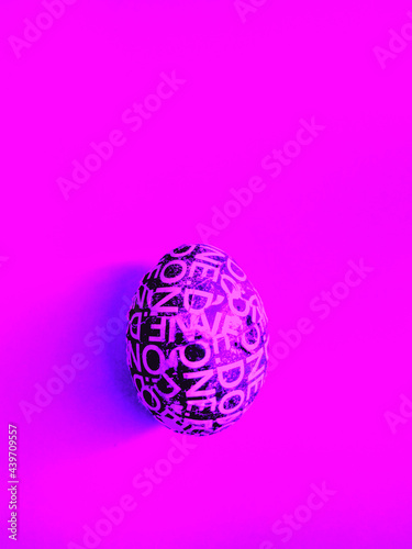 Abstract Custom made Easter egg on violet background with copyspace