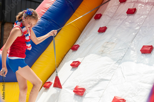 Girl playing on an inflatable climbing wall.