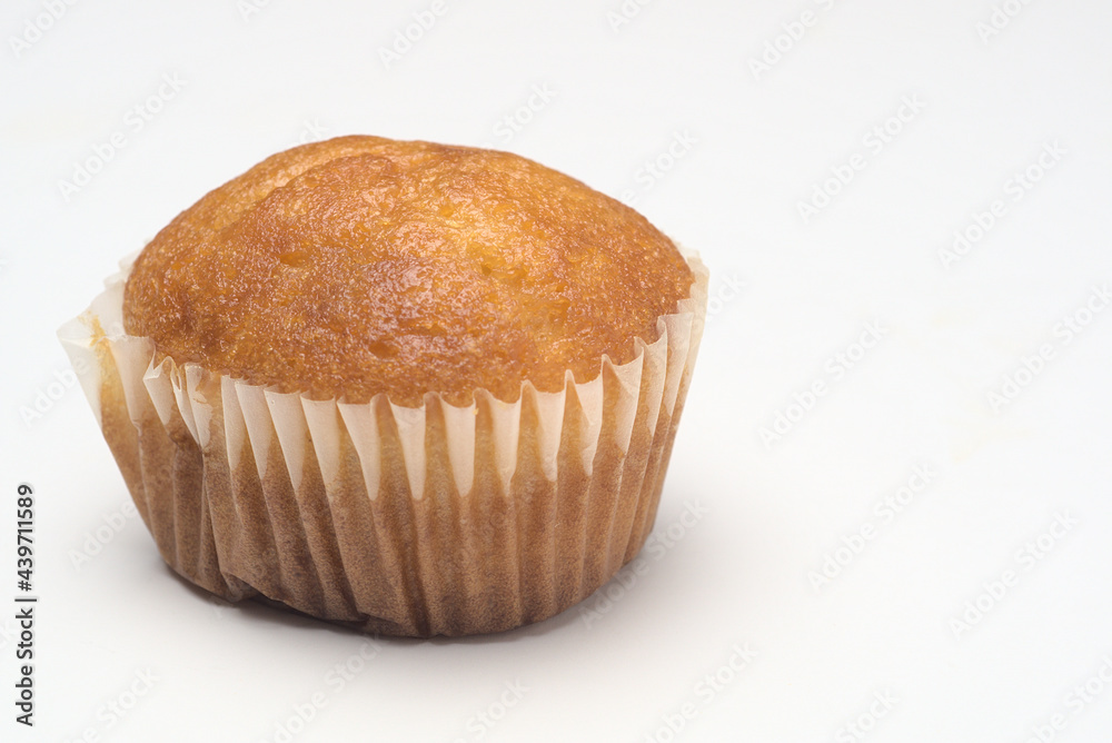 muffin in paper mold isolated on white background muffin in paper mold isolated on white background