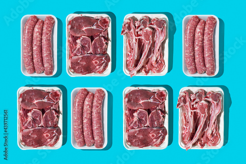 raw pork sausages and raw lamb meat cuts photo