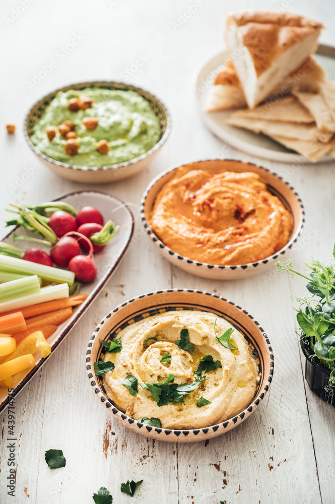 Food: different styles of hummus and vegetables Food: different styles of hummus and vegetables