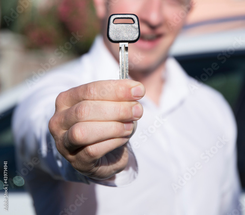 happy young man with car key 