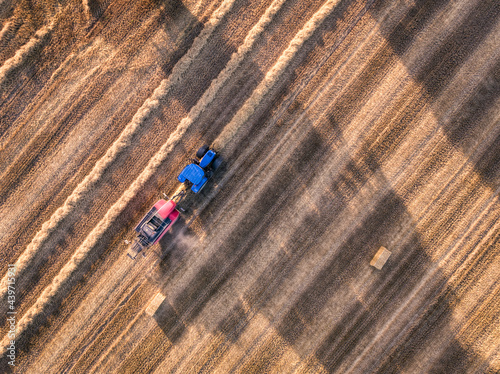 A farmer ploughing the grass in field, from above looking down