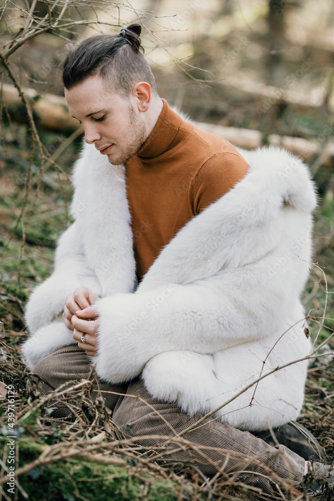 Young Man With White Fur Coat In The Woods Young Man With White Fur Coat In The Woods