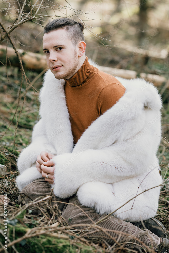 Young Man With White Fur Coat In The Woods Young Man With White Fur Coat In The Woods