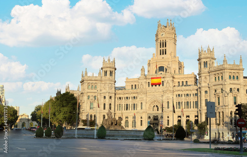 Cibeles palace and square - Cityscape of Madrid city center empty with a blue sky with clouds