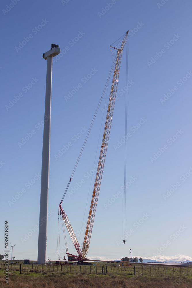 windmill being mounted by a crane