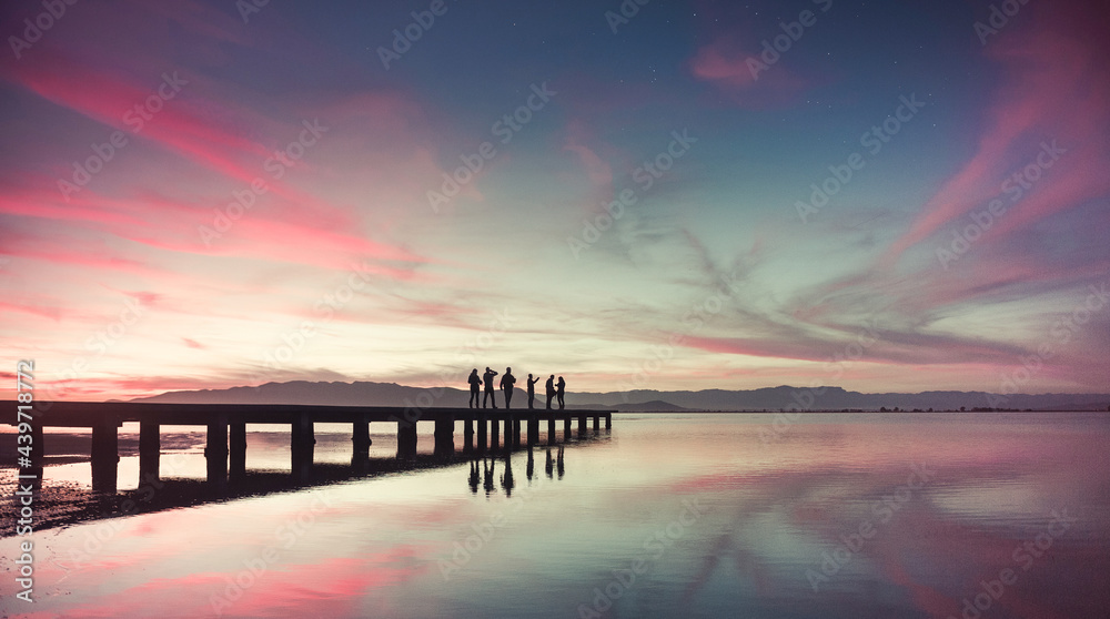 Distant human silhouette standing at the dock Distant human silhouette standing at the dock