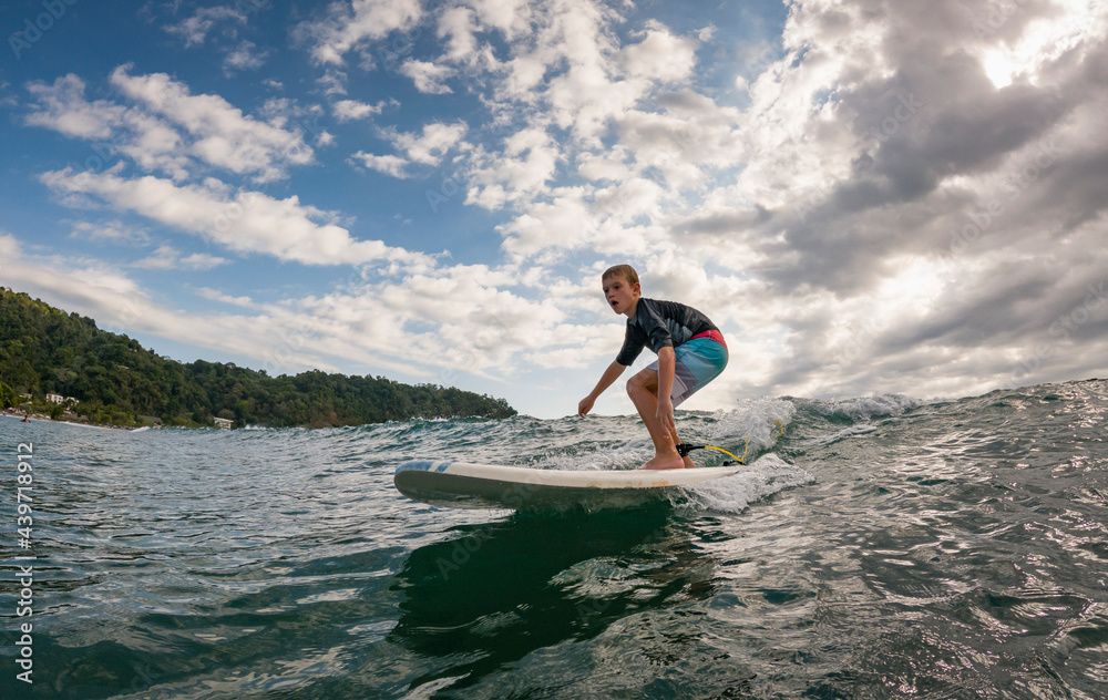 Young Boy Learning to Surf in Costa Rica Young Boy Learning to Surf in Costa Rica