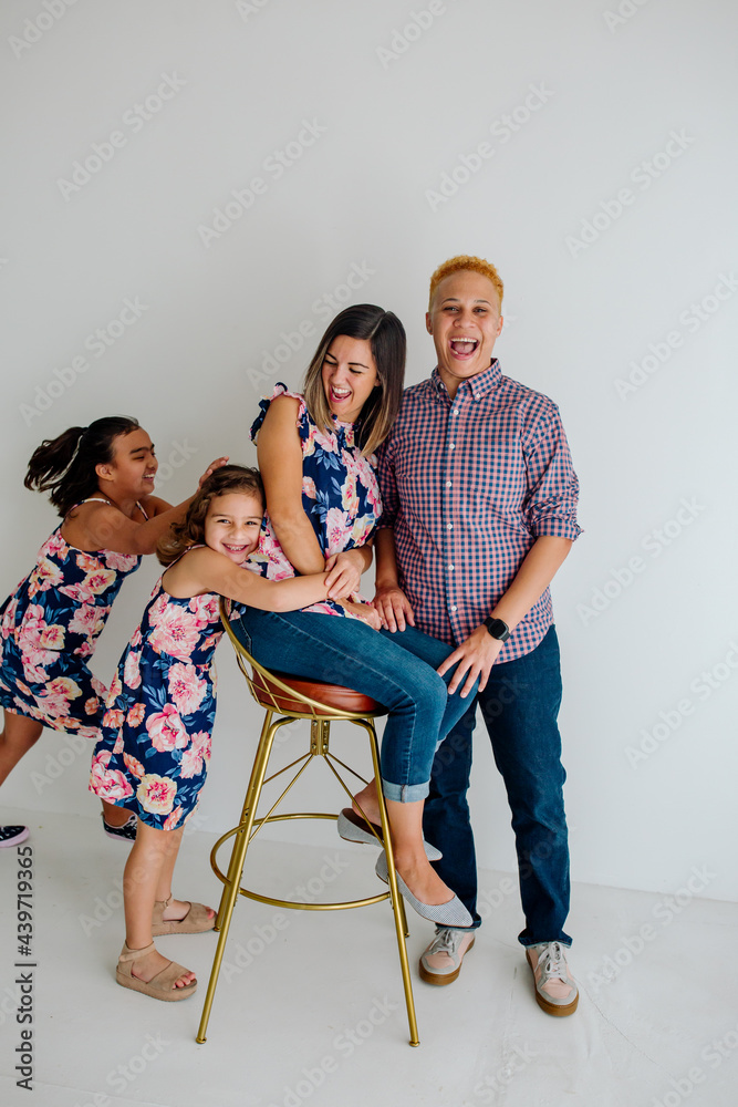 Daughters hugging happy mom Daughters hugging happy mom