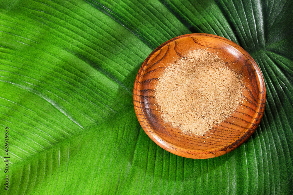 Lepidium meyenii - Peruvian maca powder in the wooden bowl Lepidium meyenii - Peruvian maca powder in the wooden bowl