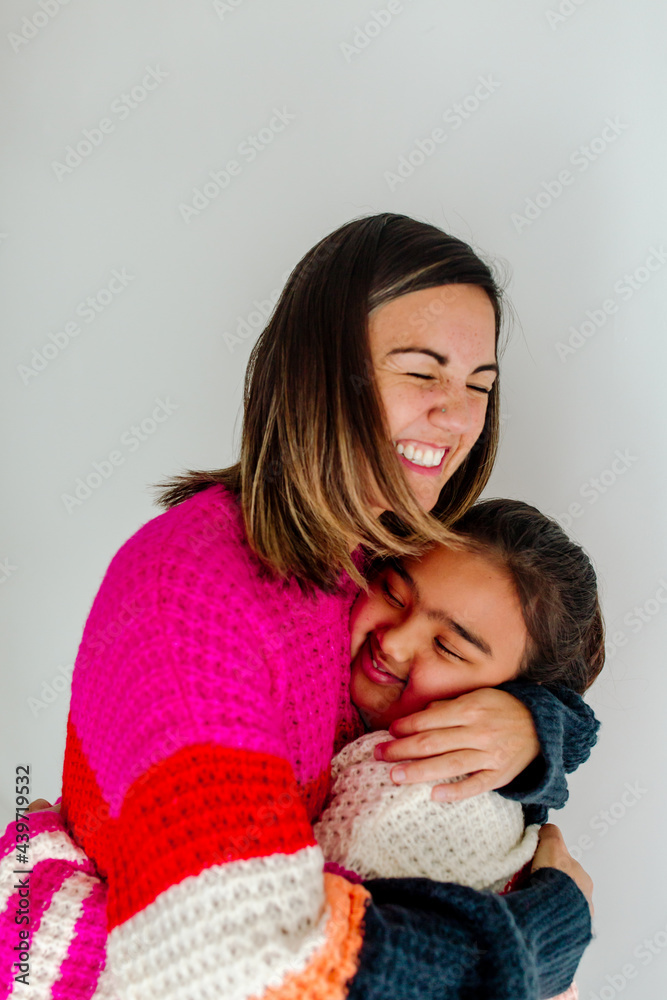 Mom hugging biracial daughter Mom hugging biracial daughter