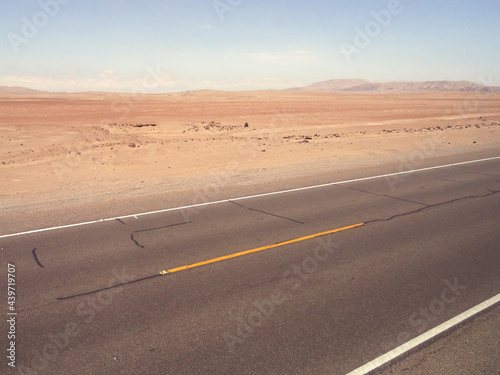 Desert of Tacna, Peru. Empty Pan-American Highway on a summer sunny day.  photo