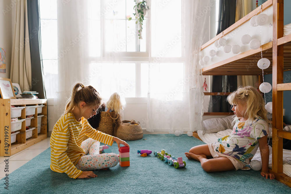 Two girls playing together in a room Stock Photo | Adobe Stock