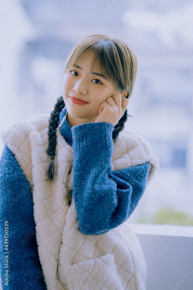 Portrait of young fashionable Asian woman with two braids Portrait of young fashionable Asian woman with two braids