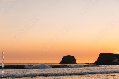 Dusky orange sunset over the ocean photo