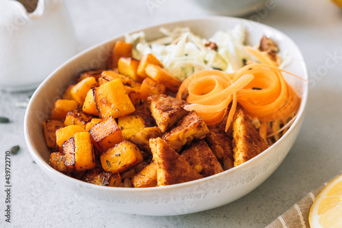 Sauteed pumpkin with spicy tempeh and fresh salad