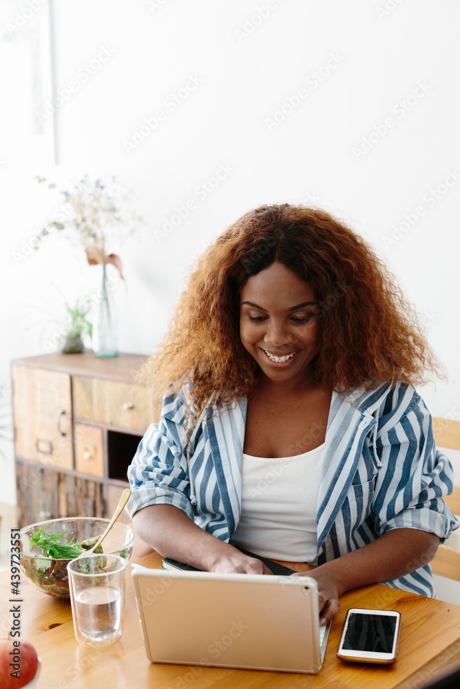 Smiley Woman working at home-office while eating Smiley Woman working at home-office while eating