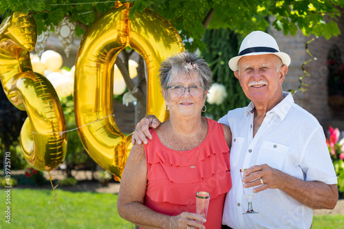 Senior Citizen Couple Portrait at Golden 50th Wedding Anniversary photo