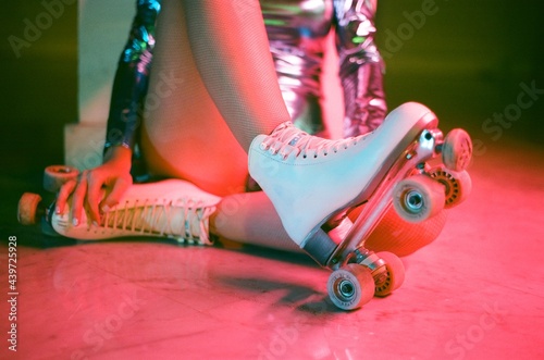 Girl on roller skates on shining suit photo