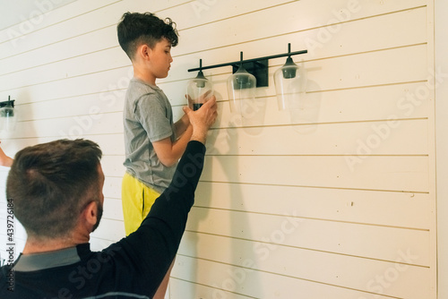Dad teaching son handy work.