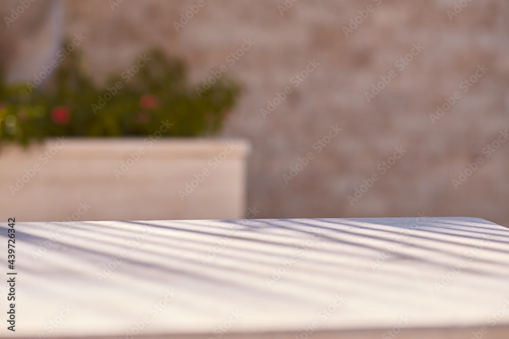 Three-dimensional trendy texture with tropical palm leaf shadows on beige natural stone wall in sunny day. Minimal trendy abstract concrete background for product presentation Three-dimensional trendy texture with tropical palm leaf shadows on beige natural stone wall in sunny day. Minimal trendy abstract concrete background for product presentation