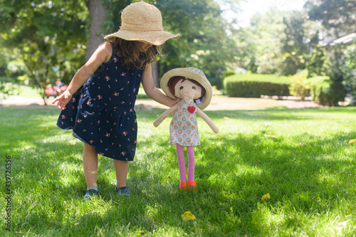 Little girl playing with her doll