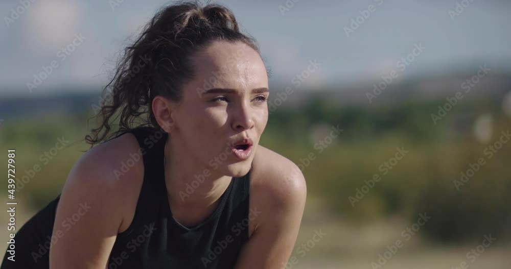 Tired Hispanic woman after jogging. smiling runner swatting looking at the camera breathes heavily. Tired Hispanic woman after jogging. smiling runner swatting looking at the camera breathes heavily.