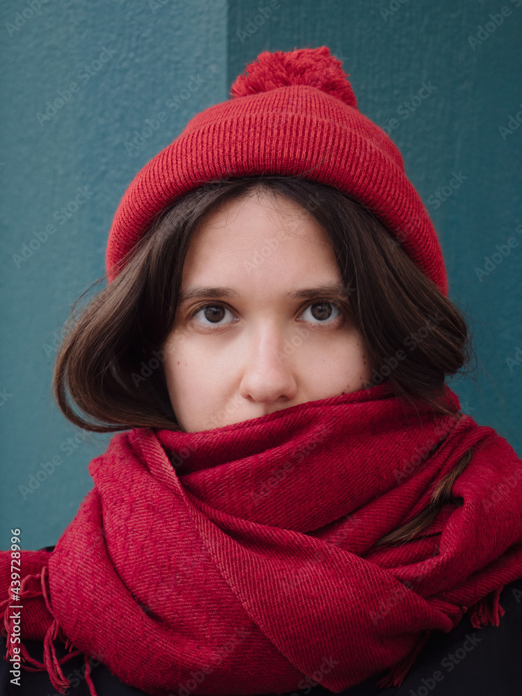 Cold look female portrait in red cap and scarf Cold look female portrait in red cap and scarf
