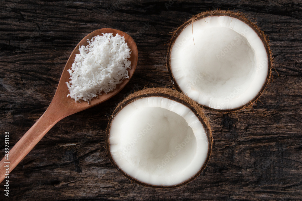 Broken dry coconut isolated over rustic wood. Broken dry coconut isolated over rustic wood.