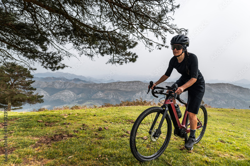 Cyclist training on electric bike in mountains Cyclist training on electric bike in mountains