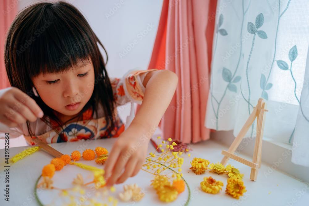 Asian kid making dried flower fan decoration DIY Asian kid making dried flower fan decoration DIY