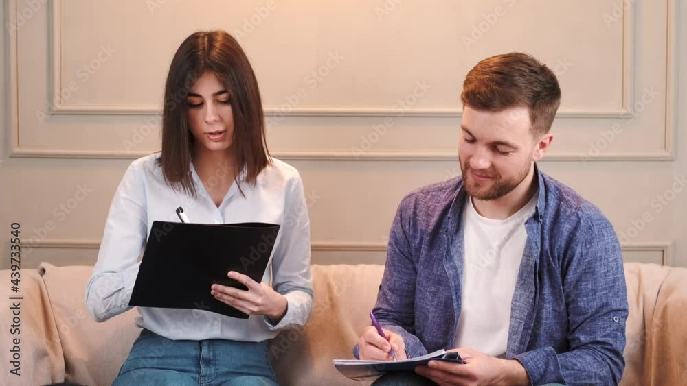 Married couple look at papers at couple counsellor Married couple look at papers at couple counsellor