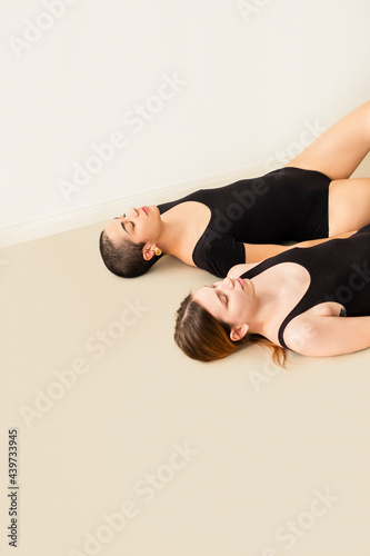 Two Women Practicing Yoga photo