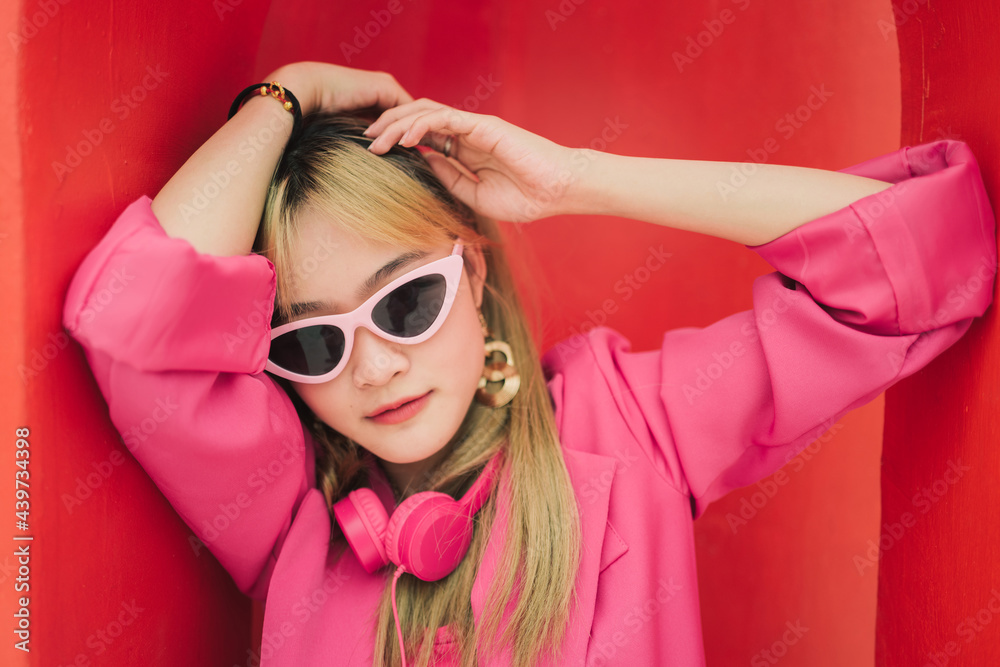 Asian fashion woman with sunglasses and earphones Asian fashion woman with sunglasses and earphones
