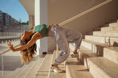 Woman stretching backward in an arc pose