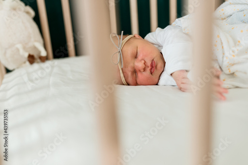 A baby laying in her crib