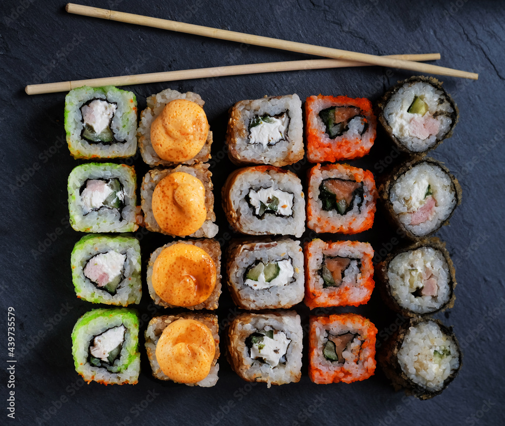 Mix of Japanese rolls in on a black background Mix of Japanese rolls in on a black background
