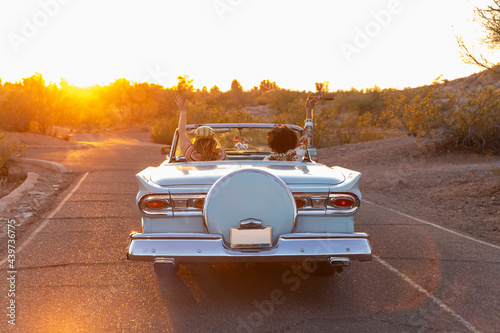 Road Trip in Vintage Car in Arizona at Sunset photo