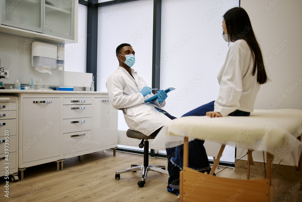 Woman having consultation in hospital with doctor Woman having consultation in hospital with doctor