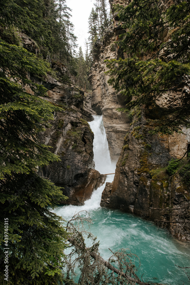 Glacier river waterfall in a canyon 